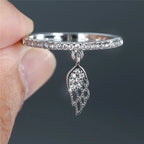 Ring with silver angel wings pendant