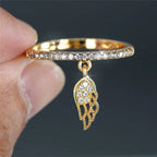 Ring with gold angel wings pendant
