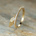 Ring with gold angel wings pendant