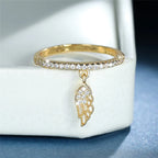 Ring with gold angel wings pendant