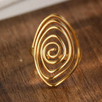 Wide textured spiral ring in gold