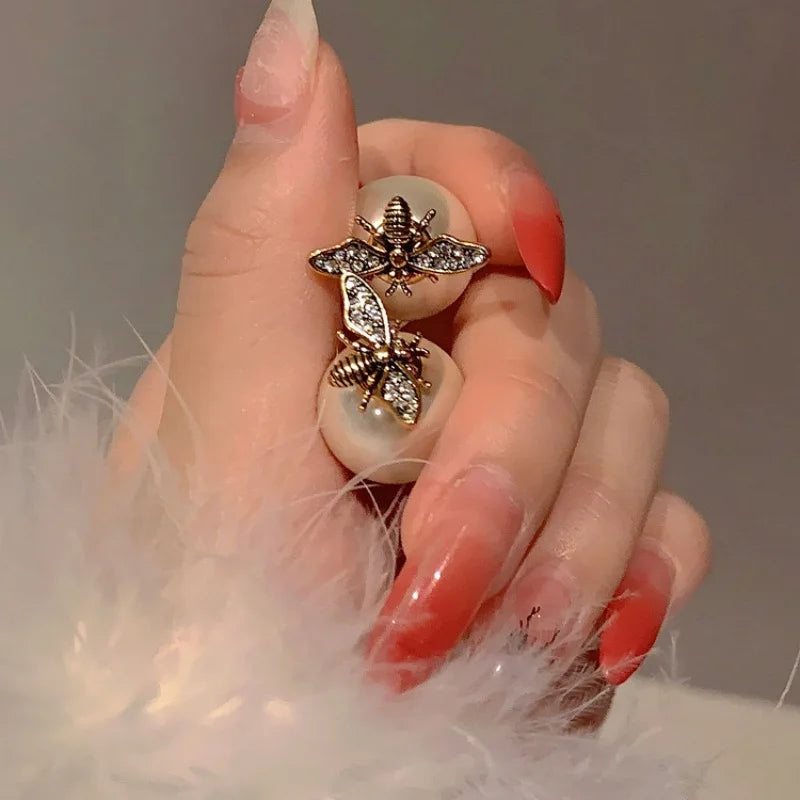 Bee and white pearl earrings