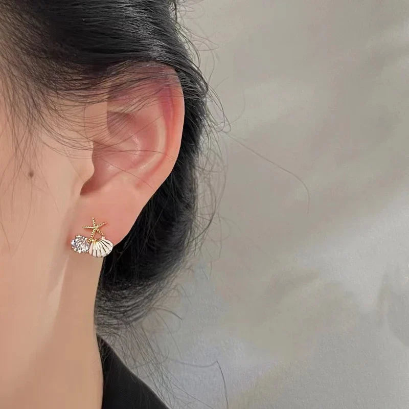 Asymmetrical white seashell earrings