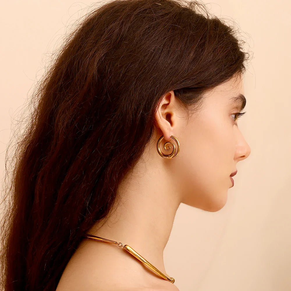 Gold hoop earrings with spiral motif