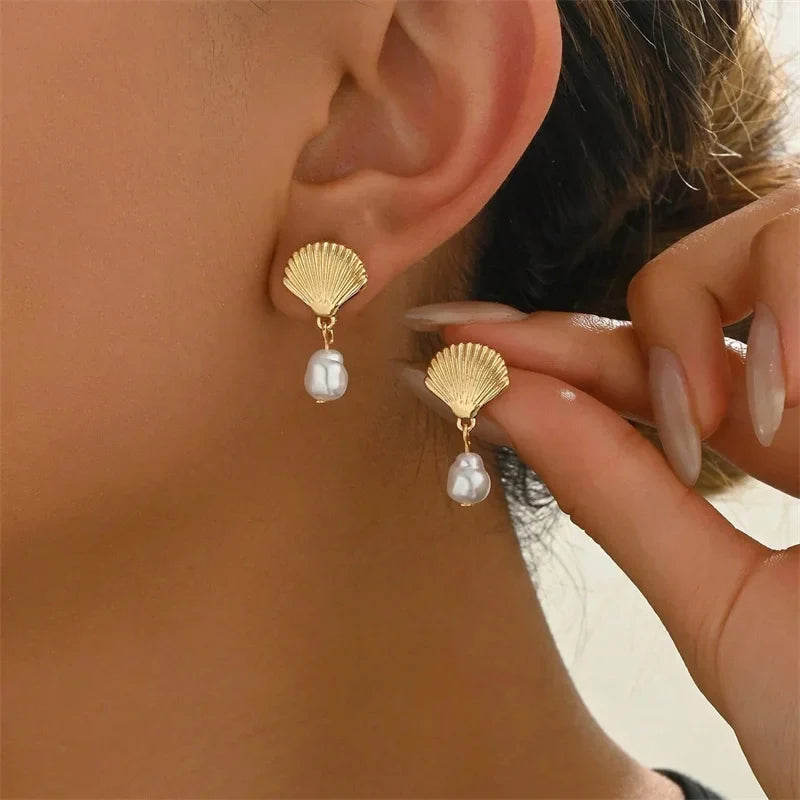 Gold shell and pearl earrings