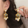 Blue Eye and Pearl Drop Earrings gold