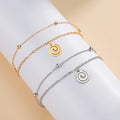 Gold bracelet with small gold spiral charm