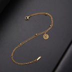 Gold bracelet with small gold spiral charm