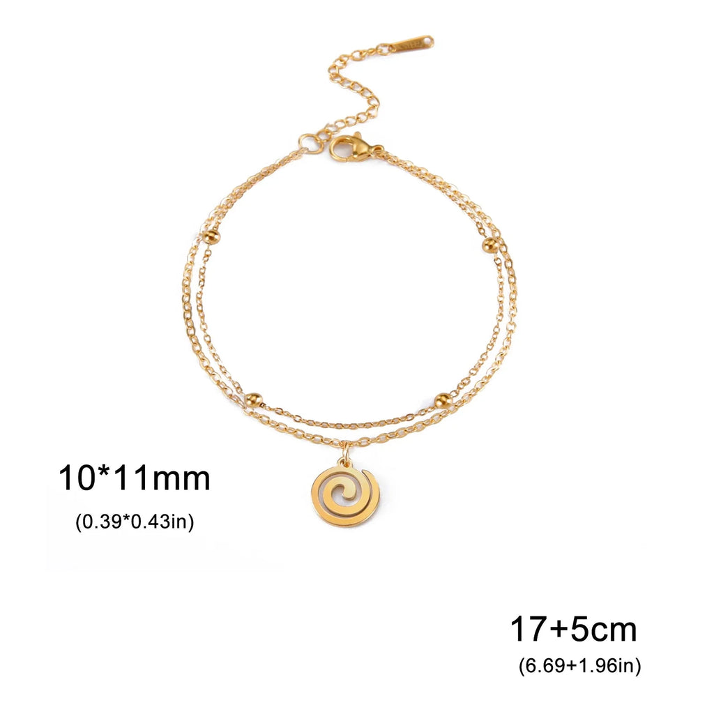 Gold bracelet with small spiral charm