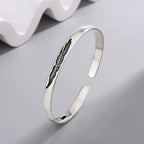 Open bangle bracelet with silver feather