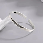 Open bangle bracelet with silver feather