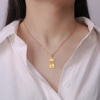 Necklace with palm tree and beach wave pendant in gold