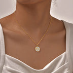 Necklace with round pendant and palm tree motif