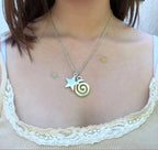 Necklace with spiral pendant and small star