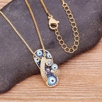 Necklace with Tongue, Blue Eye, and Zircon Pendant