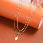 Double Necklace with Blue Turkish Eye and Fatima Hand Pendant Gold