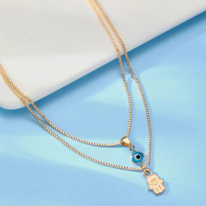 Double Necklace with Blue Turkish Eye and Fatima Hand Pendant Gold