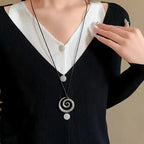 Long necklace with silver spiral pendant