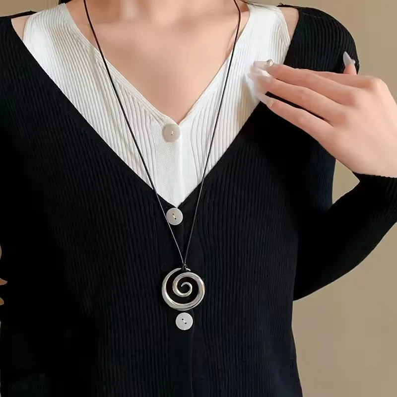 Long necklace with silver spiral pendant