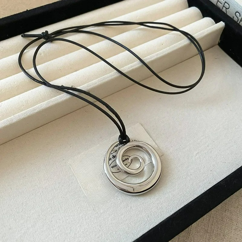 Long necklace with silver spiral pendant