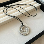 Long necklace with silver spiral pendant
