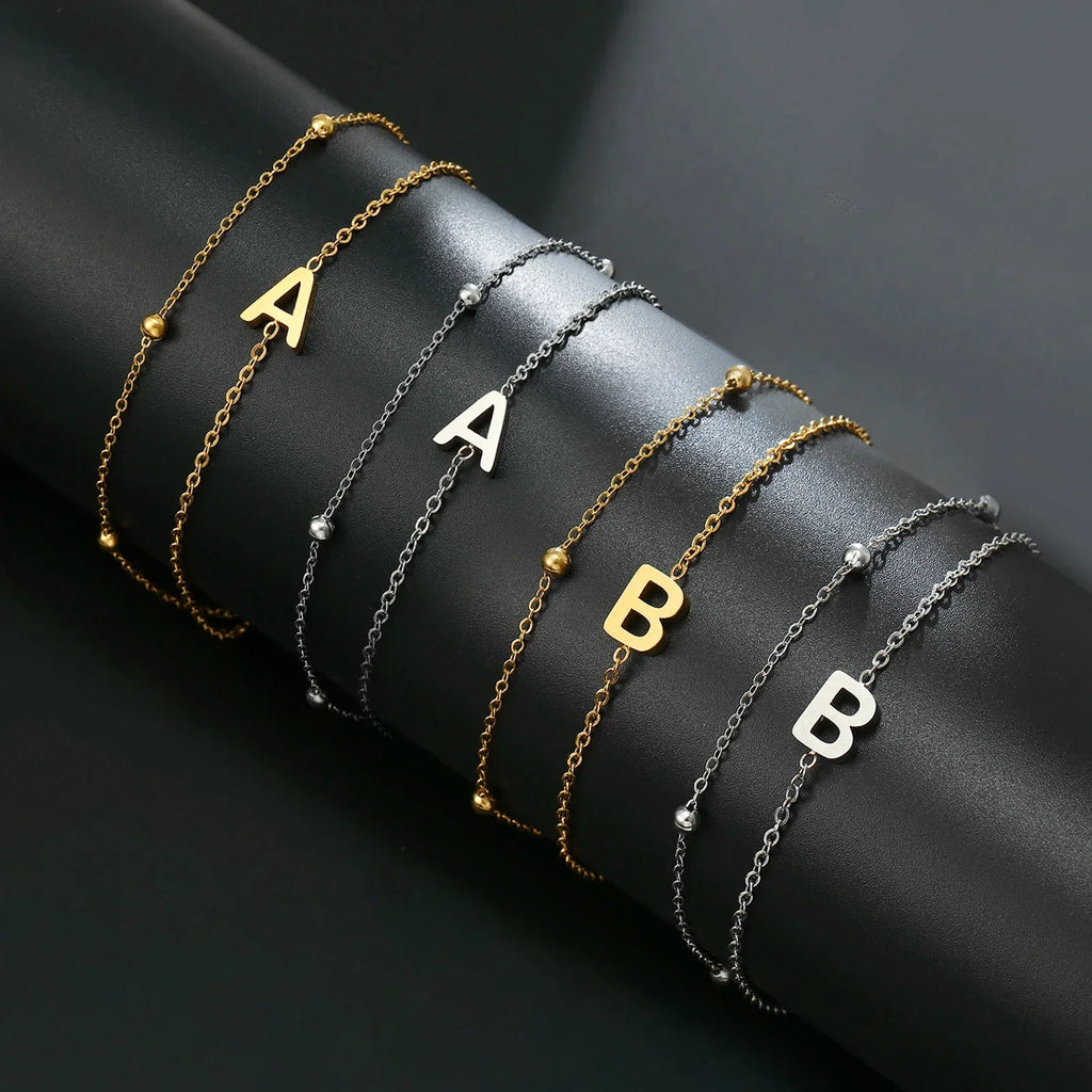 Double initial bracelet gold and silver