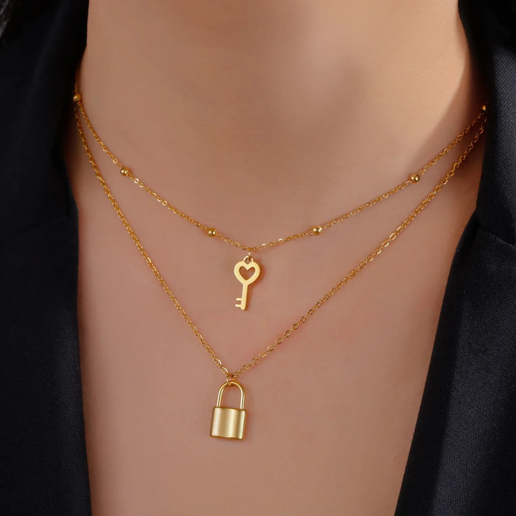 Double necklace with gold key and padlock pendant
