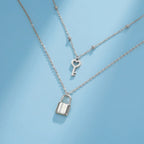 Double necklace with silver key and padlock pendant