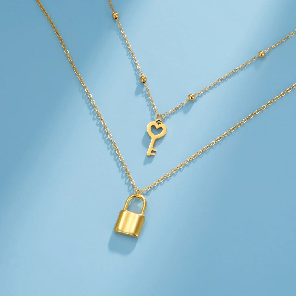 Double necklace with gold key and padlock pendant
