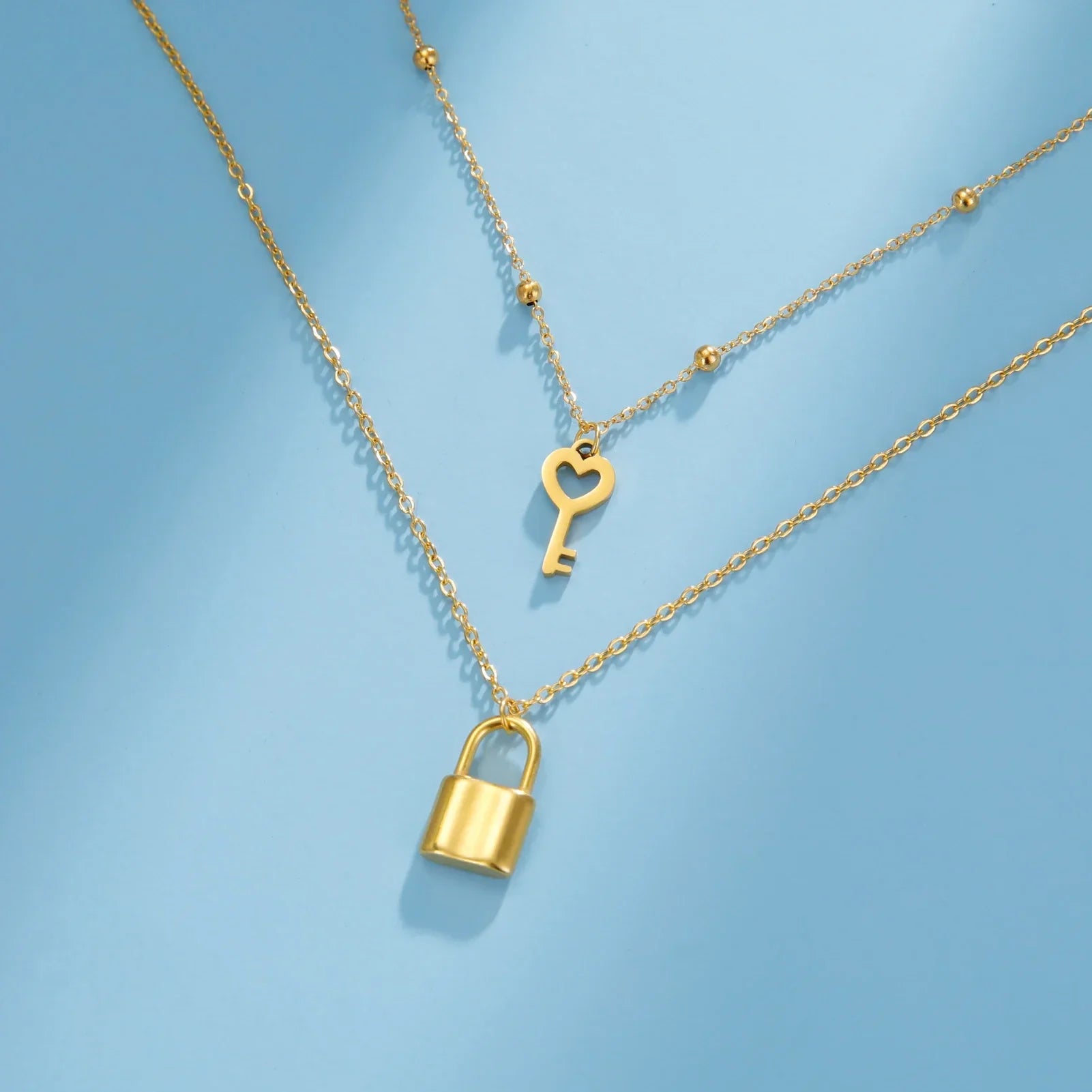 Double necklace with gold key and padlock pendant