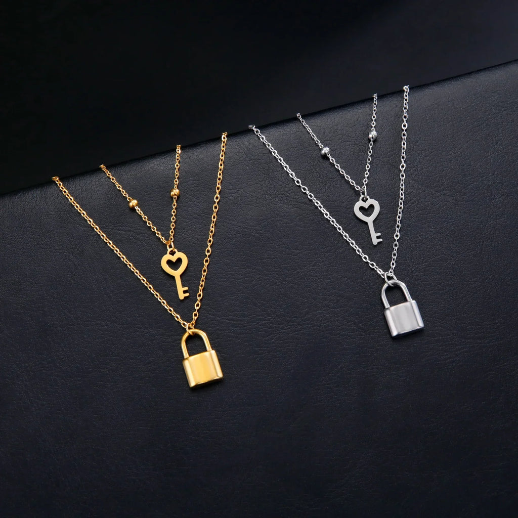 Double necklace with gold key and padlock pendant