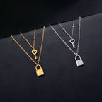 Double necklace with gold key and padlock pendant