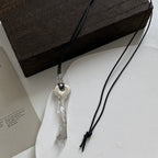 Long rope necklace with shiny silver key pendant