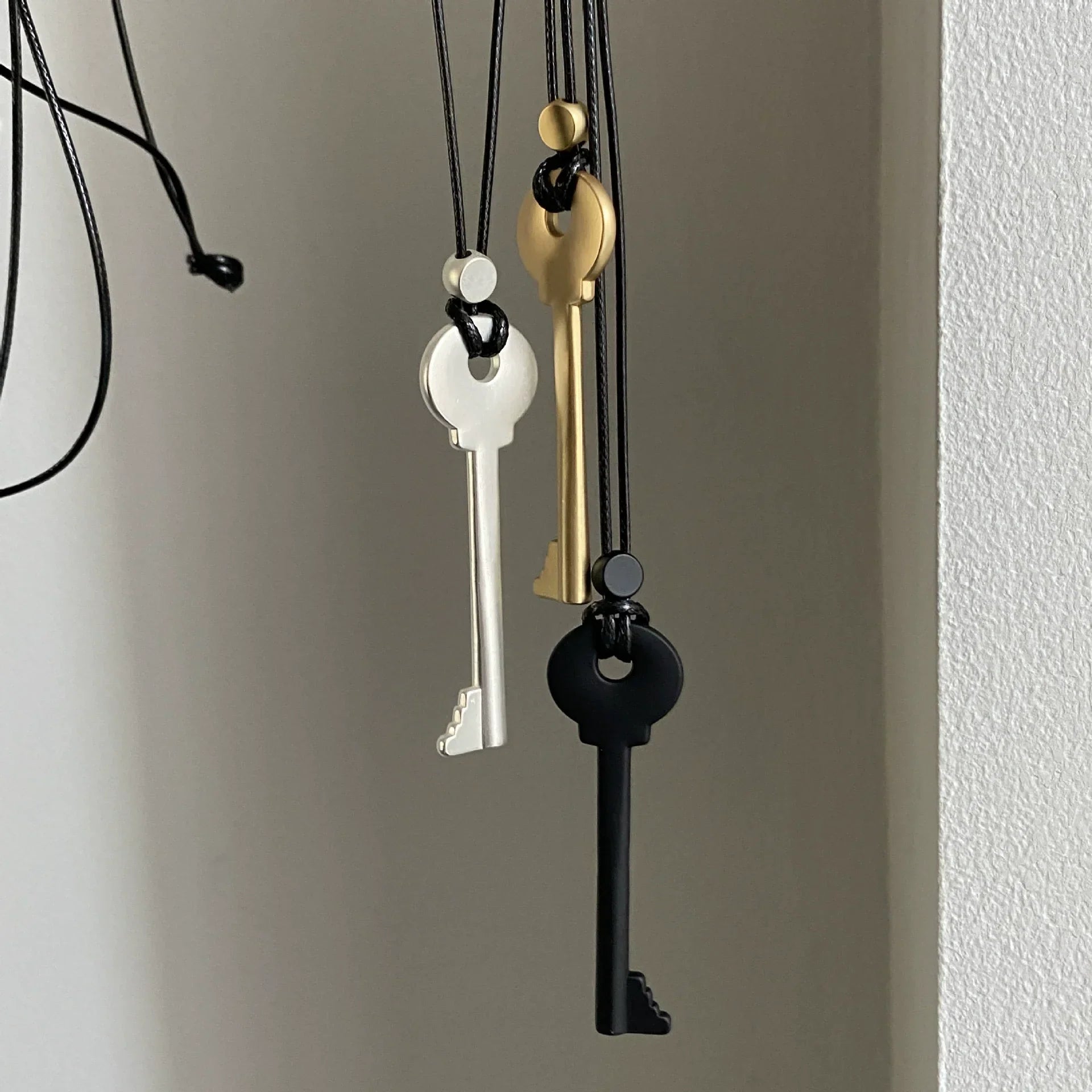 Long rope necklace with black key pendant