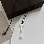 Long rope necklace with matte silver key pendant