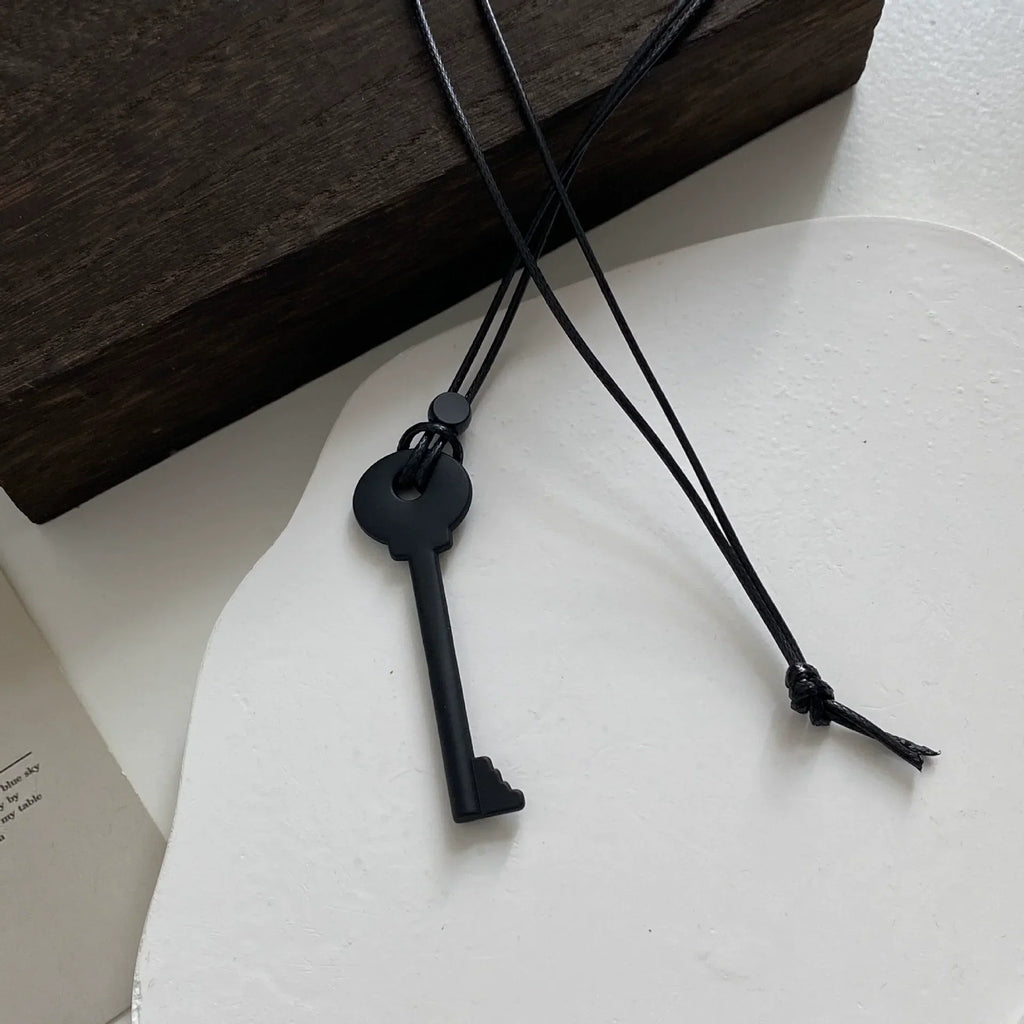 Long rope necklace with black key pendant