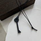 Long rope necklace with black key pendant