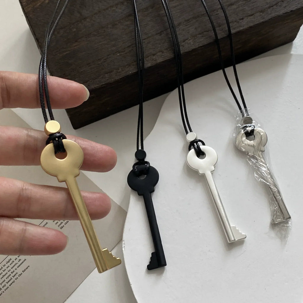 Long rope necklace with gold key pendant