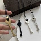 Long rope necklace with gold key pendant