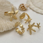 Set of 4 shell and starfish rings gold