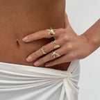 Set of 4 shell and starfish rings gold