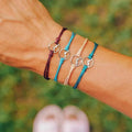 Set of 4 Cord Bracelets with Round Mountain Pendant