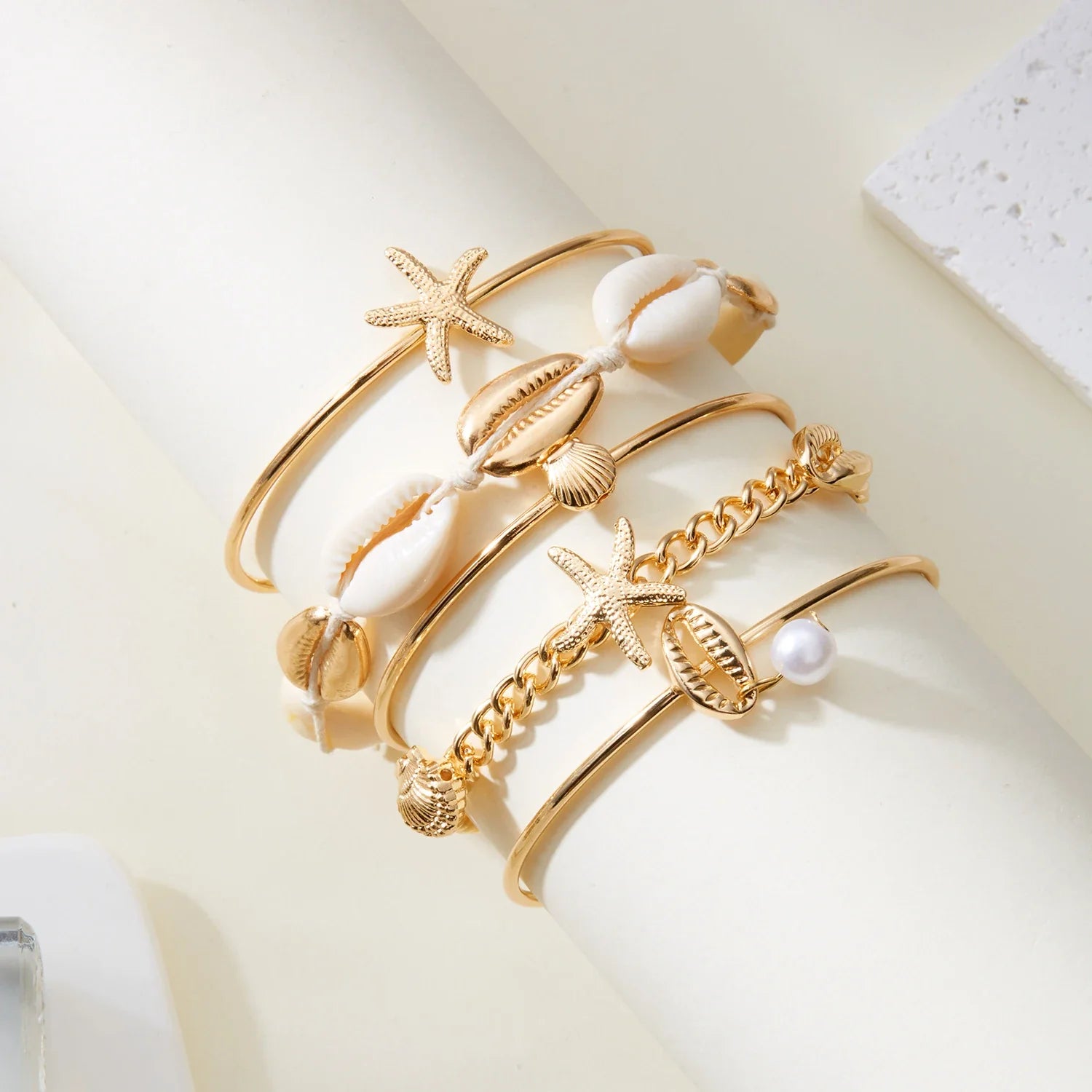 Set of 5 gold shell and star bracelets