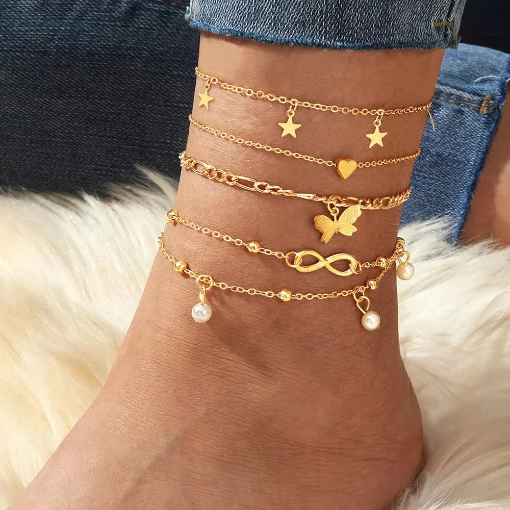 Set of 5 anklets: star, infinity, butterfly, beads, and heart